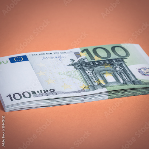 Euro cash on a pink and orange background. Euro Money Banknotes. Euro Money. Euro bill. Place for text. photo