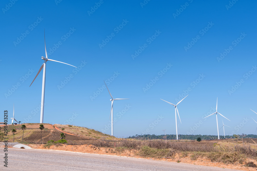 Wind turbine is alternative electrical power with blue sky, summer field, renewable energy Wind turbine is alternative electrical power with blue sky, summer field, renewable energy