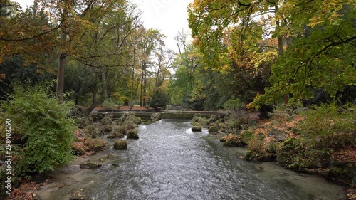 Flowing river with rocks in foreground, the Isar in Munichs Englischer Garten. photo