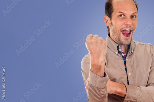 young man showing negative sign on blue color background photo