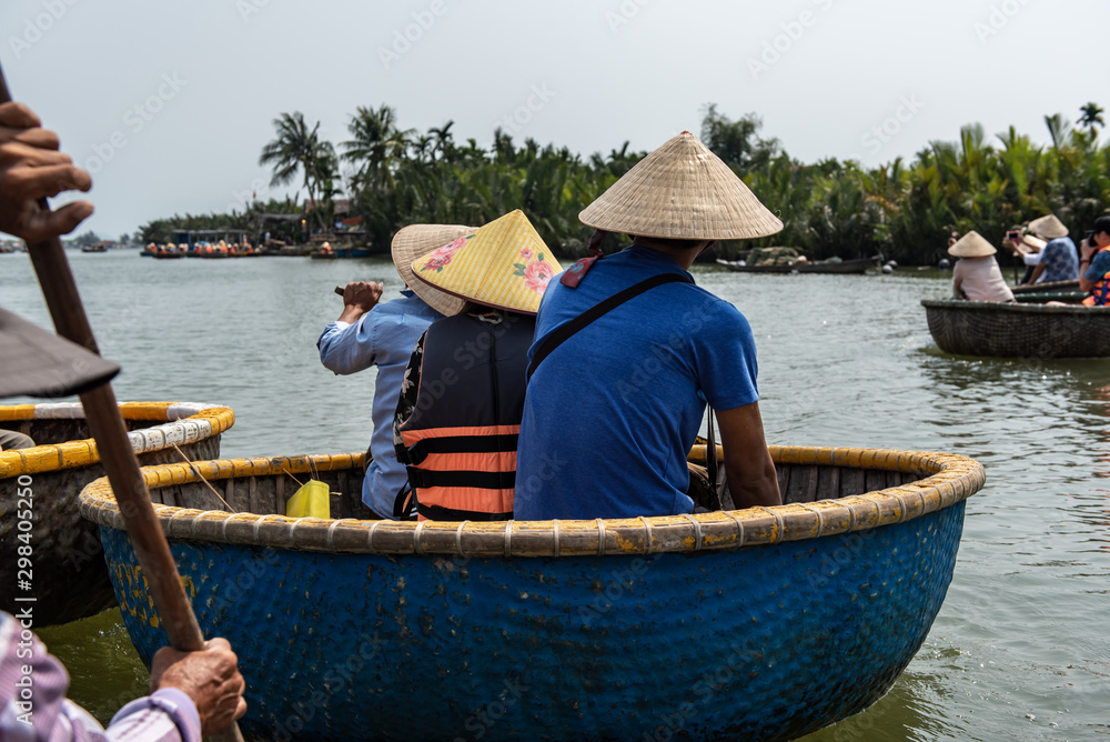 traveller people sitting in the Vietnam traditional bamboo basket boat in the canal at Da Nang, Vietnam.