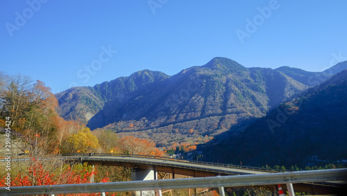 scenic landscape view of nature with highway road and big mountain blue sky background in autumn , japan.