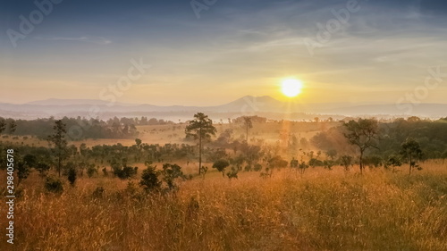 Mountain view panorama misty morning on grass fields around with soft fog and yellow sun light background, sunrise at Thung Salang Luang, Khao Kho, Phetchabun, Thailand.