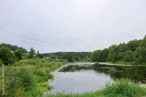 Beautiful lake and a village in russian outback surrounded by forest