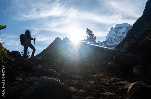 Active hiker hiking, enjoying the view, looking at Himalaya mountains landscape. Travel sport lifestyle concept