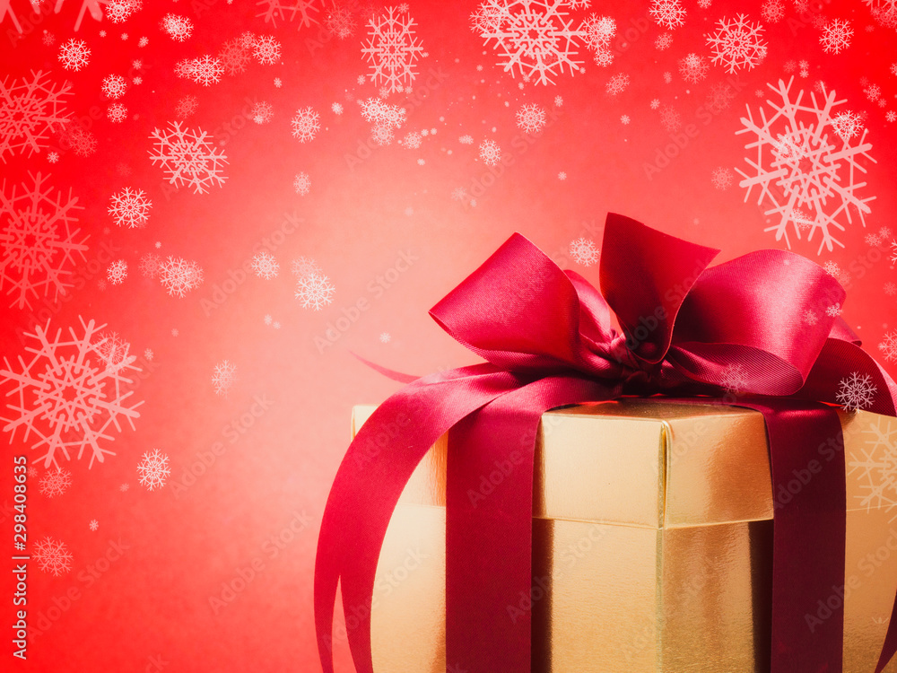 Valentine festival , New year Gold gift box with red ribbon. Red background and snowflake for create idea copy space. Valentine festival , New year Gold gift box with red ribbon. Red background and snowflake for create idea copy space.