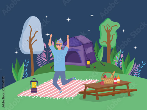 jumping man wearing sunglasses lantern blanket table tent camping picnic