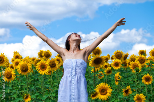 Young beautiful girl in a field of sunflowers field