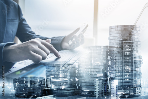 double exposure of businessman working at office with step of coins and city night, financial and investment concept