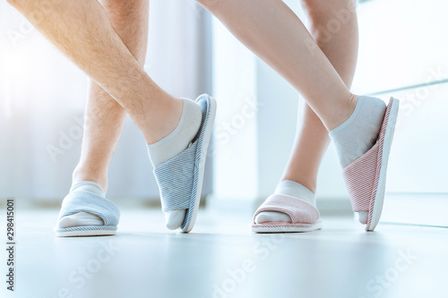 Loving family couple together in cozy soft comfortable slippers at home. Family love concept