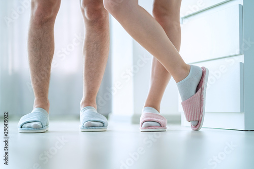 Loving family couple together in cozy soft comfortable slippers at home. Family love concept