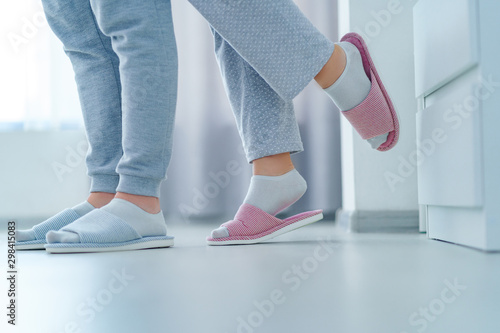 Loving married couple together in home soft comfortable slippers, family concept
