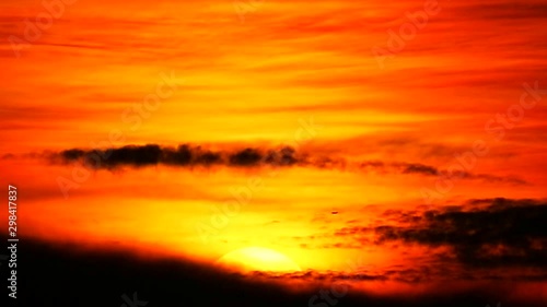 sunset on dark red cloud and orange sky and silhouette airplane flying pass the sun1 photo