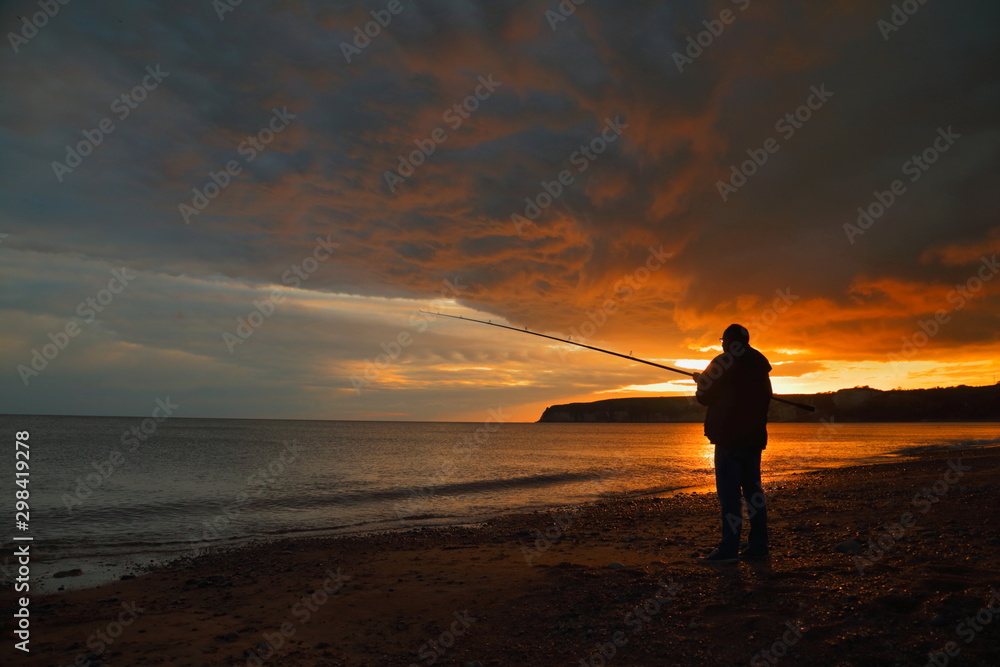 Fly fishing at sunset on the Jurassic Coast in Devon