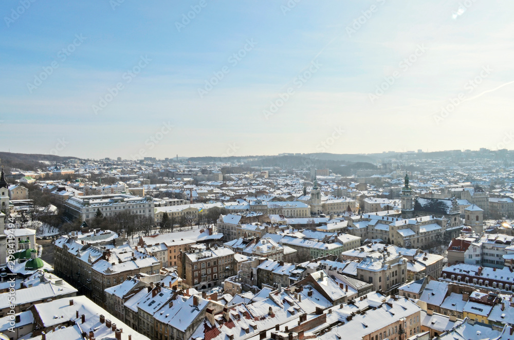 Beautiful city panorama in winter with snow covered houses and streets. Aerial evening view. Winter city scenery