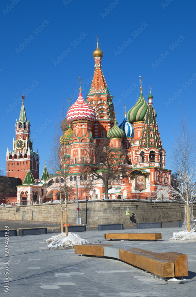 Cathedral of the Intercession of the blessed virgin Mary, on the Moat (St. Basil's Cathedral) and the Spasskaya tower of the Moscow Kremlin on a Sunny spring day. Moscow, Russia