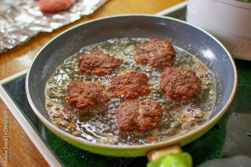 Μeat balls are fried in a pan with hot oil.Food concept. © Lazaros