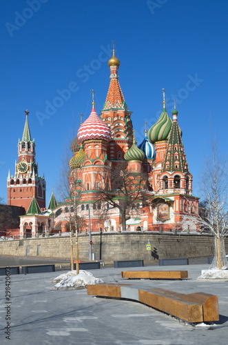 Cathedral of the Intercession of the blessed virgin Mary, on the Moat (St. Basil's Cathedral) and the Spasskaya tower of the Moscow Kremlin on a Sunny spring day. Moscow, Russia