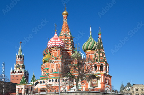 St. Basil's Cathedral and the Spasskaya tower of the Moscow Kremlin on a Sunny spring day. Moscow, Russia