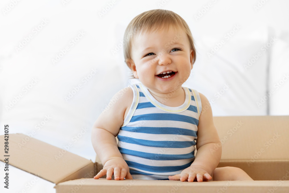 Smiling baby boy sitting in delivery box Smiling baby boy sitting in delivery box