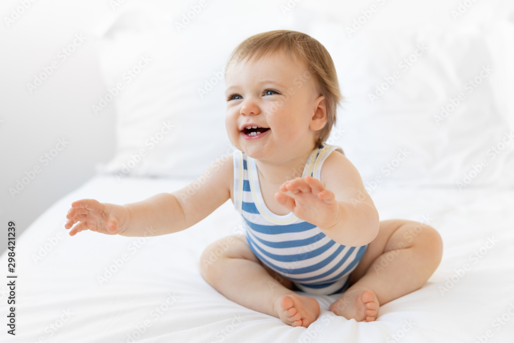 Laughing baby boy reaching out with arms extended Laughing baby boy reaching out with arms extended