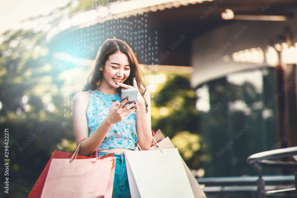Asian woman hold red bag and using smartphone Asian woman hold red bag and using smartphone