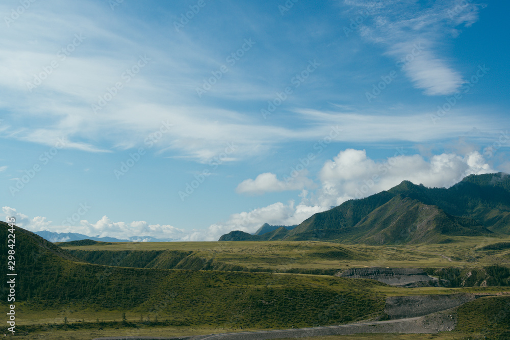Fototapeta premium Rocks under blue sky with clouds. Mountain Hiking, summer tourism