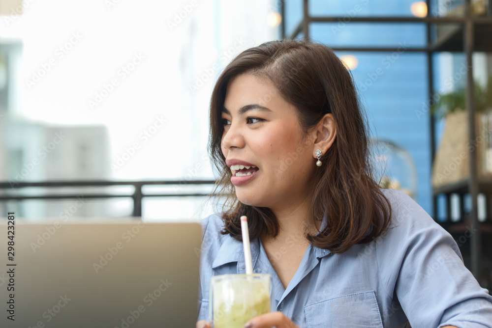 Asian woman eating green tea ice cream and talking with friend at cafe, lifestyle concept. Asian woman eating green tea ice cream and talking with friend at cafe, lifestyle concept.