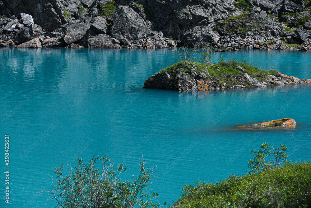 Turquoise lake among rocks. Mountain pond for hiking
