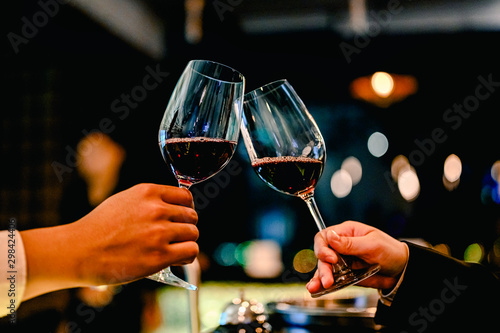Young businessmen and women are drinking wine to celebrate the night of new business success together. Togetherness Concept.