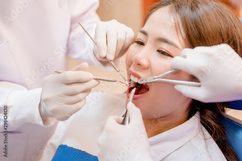 Dentist examining teeth patients in clinic for better dental health and a bright smile.