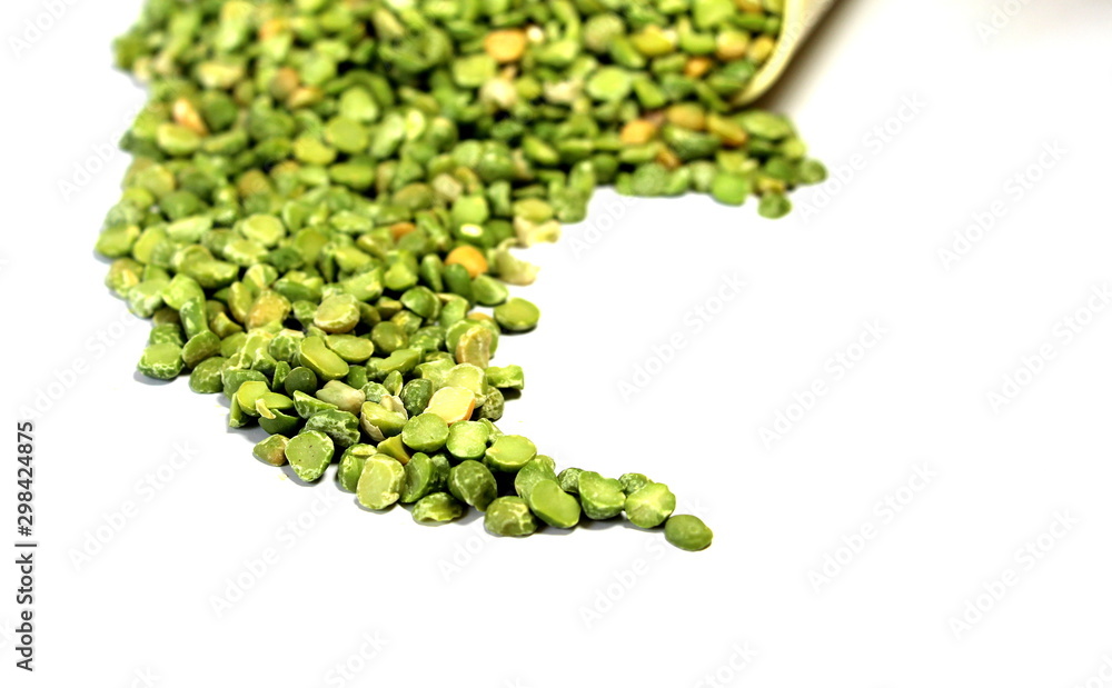 Dry green peas on a white background. Pea texture. Chipped dry peas for soup. Dry green peas on a white background. Pea texture. Chipped dry peas for soup.
