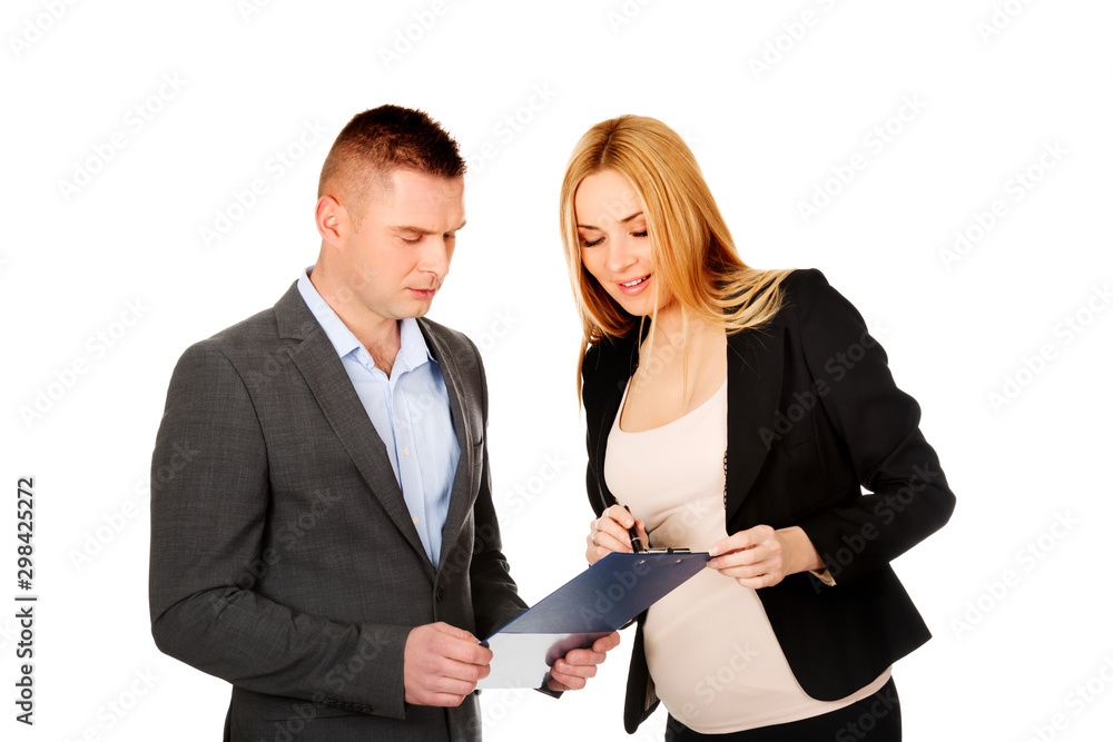 Pregnant businesswoman showing her notes to boss or colleague. Pregnant woman in work. Pregnant businesswoman showing her notes to boss or colleague. Pregnant woman in work.