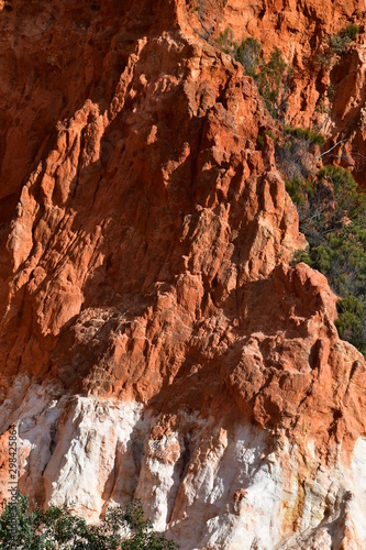 Closeup of part of the Pinnacles eroding cliffs of red gravel clay on soft white sand in Ben Boyd National Park south of Pambula, on the New South Wales Sapphire Coast, Australia