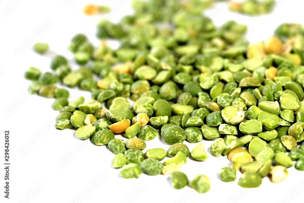 Dry green peas on a white background. Pea texture. Chipped dry peas for soup. Dry green peas on a white background. Pea texture. Chipped dry peas for soup.