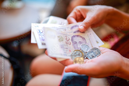 Photography Hand hold a singapore dollar banknote ready for shopping, Singapore currency many value in shopping