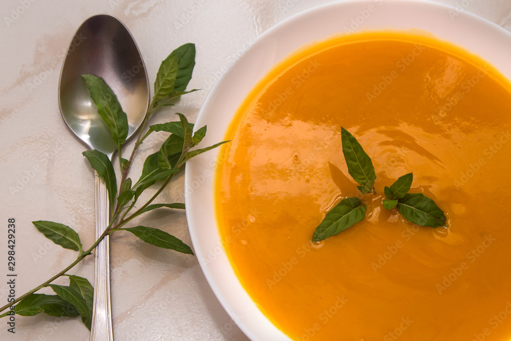 bowl with pumpkin soup on background bowl with pumpkin soup on background