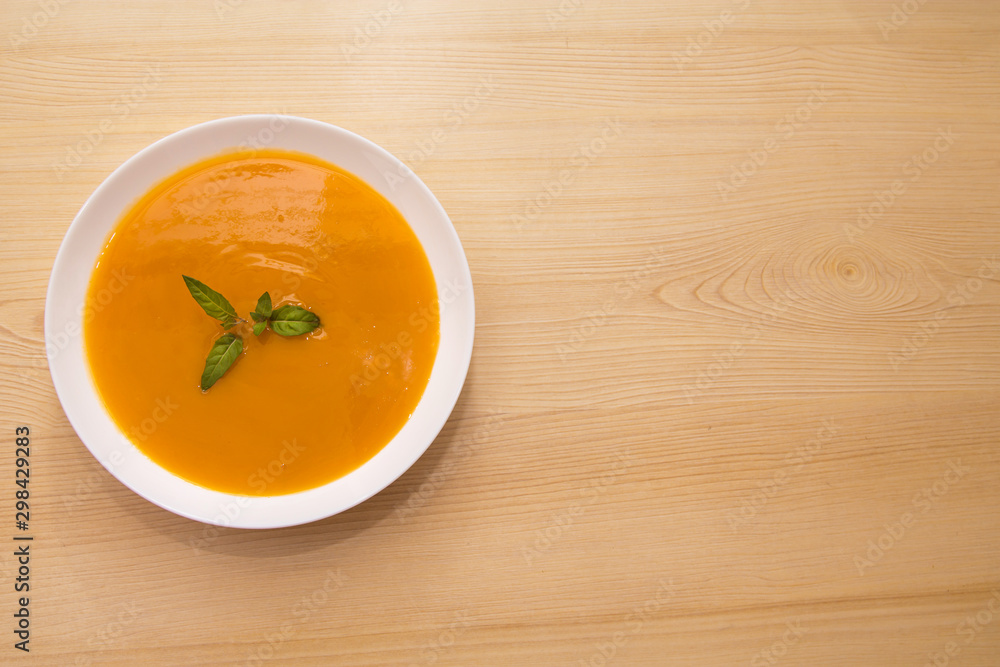 bowl with pumpkin soup on background bowl with pumpkin soup on background