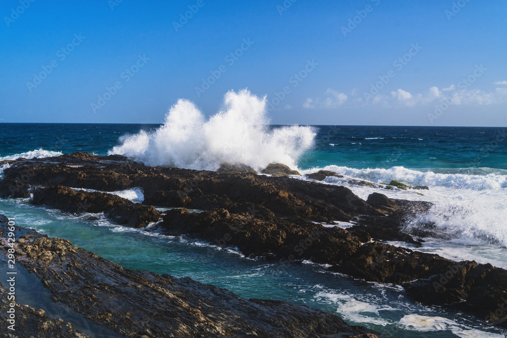 Beautiful landscape view of surfing waves crashing against the beach at Snapper Rocks, Coolangatta, Gold Coast, Queensland, Australia.