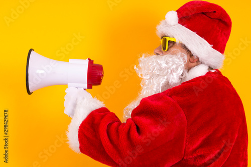 santa claus with megaphone on yellow background