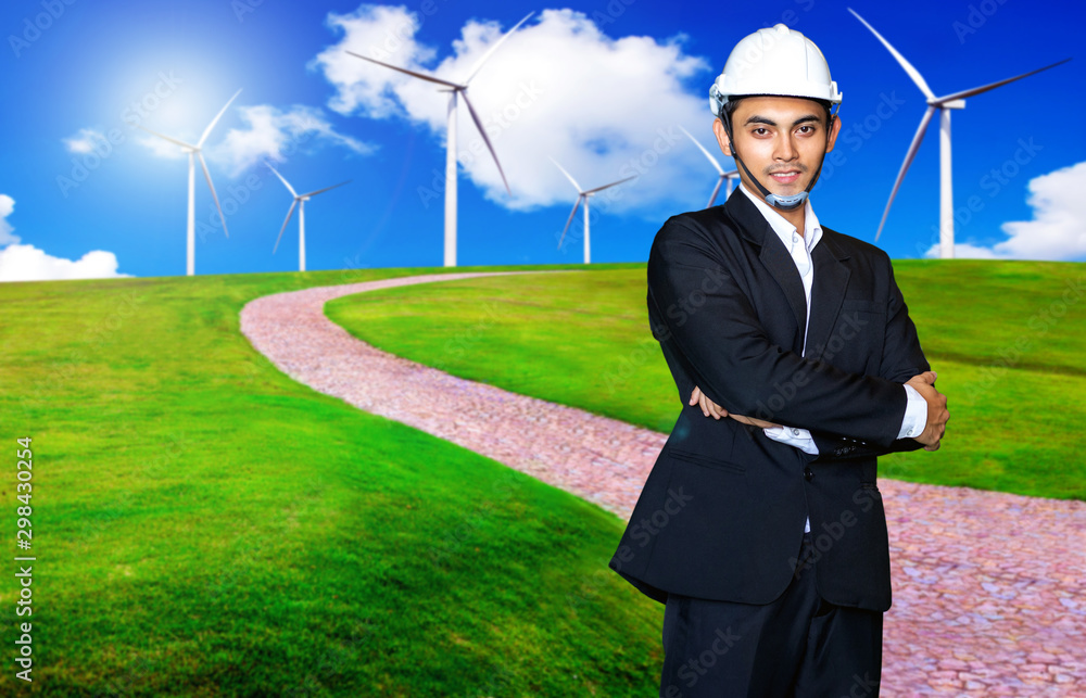 Windmill engineer or businessman standing on the wind turbine energy production and beautiful landscape Windmill engineer or businessman standing on the wind turbine energy production and beautiful landscape