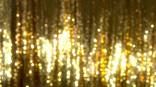 Golden seguin background with shiny reflection. Luxury disco or nightclub.