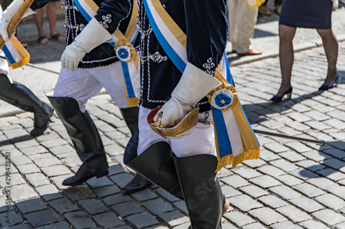 Close-up of uniform of members of student fraternity walking on cobbled street photo