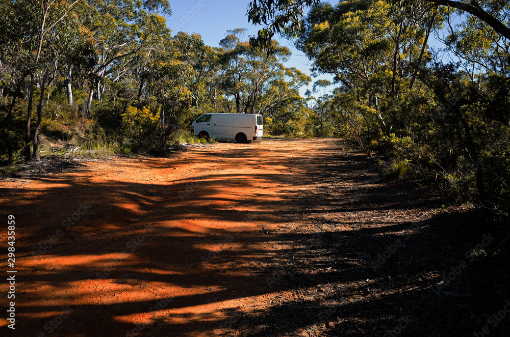 White van parked along dirt road in Australian bush White van parked along dirt road in Australian bush