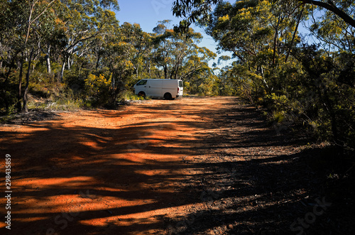 White van parked along dirt road in Australian bush