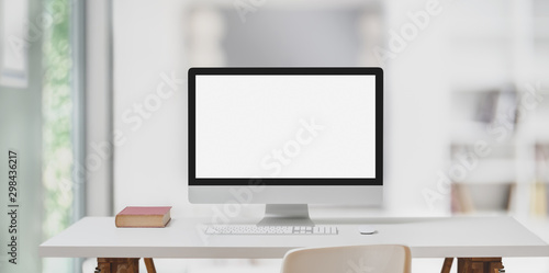 Modern workspace with desktop computer and decorations on white table and blurred background