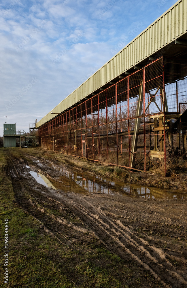 Detailed view of he long conveyor system used to transport mined aggregates away to an out of view processing facility. Detailed view of he long conveyor system used to transport mined aggregates away to an out of view processing facility.