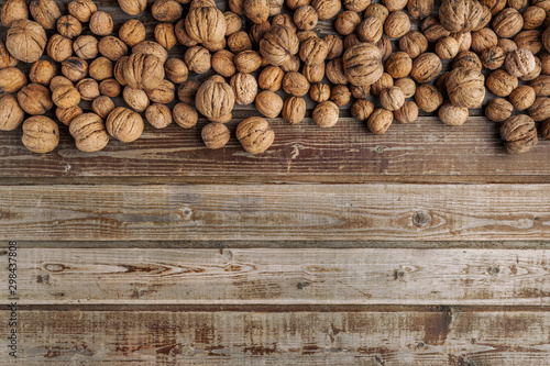 Walnuts on old vintage wooden background. Wood boards. Natural wood. Rustic style. The view from the top. Space for text.