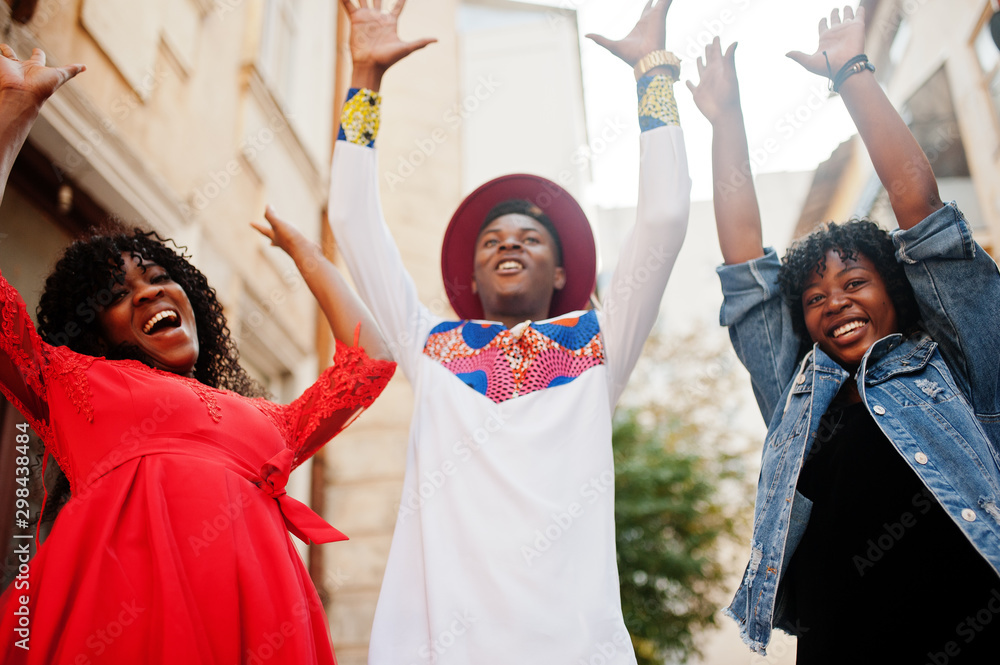 Group of three stylish trendy afro france friends posed at autumn day. Black african man model with two dark skinned womans.