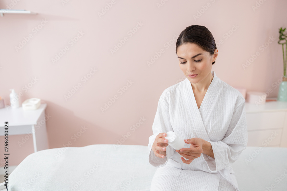 Beautiful young woman holding bottle of vitamins Beautiful young woman holding bottle of vitamins
